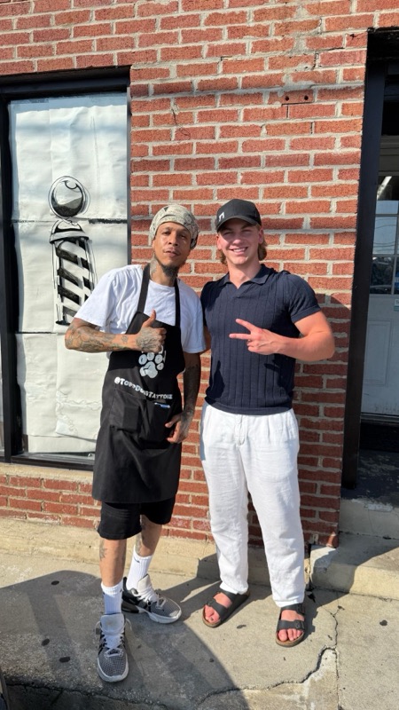 With a tattoo artist outside his studio