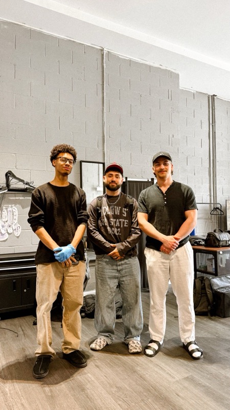 In a tattoo studio with two artists